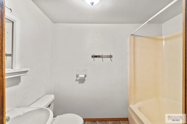 bathroom featuring  shower combination and toilet