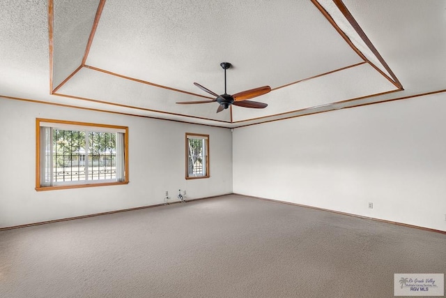 spare room with a textured ceiling, carpet floors, and ceiling fan