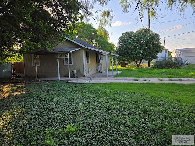 exterior space with entry steps, a yard, a patio, and fence