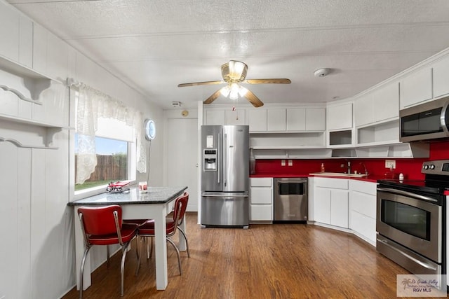 413 Cooper Ln Unit 24, 25, 26, La Feria, TX 78559 - kitchen with appliances with stainless steel finishes, open shelves, dark wood-style flooring, a sink, and white cabinets