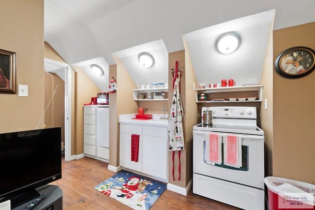 413 Cooper Ln Unit 24, 25, 26, La Feria, TX 78559 - kitchen with white electric stove, wood finished floors, lofted ceiling, open shelves, and a sink