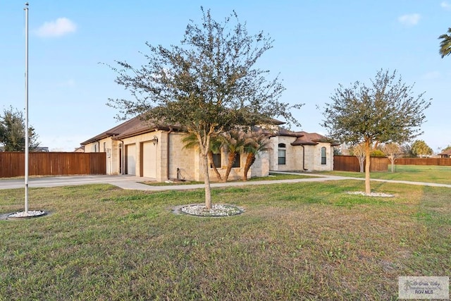 view of front facade with a garage and a front lawn