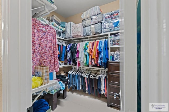 walk in closet with tile patterned flooring