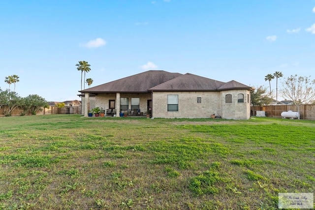 back of property featuring a lawn