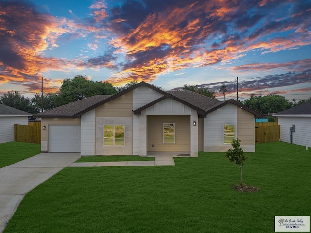 ranch-style home with a lawn and a garage