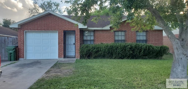 4853 Paseo Del Rey Dr, Brownsville, TX 78526 - ranch-style house featuring brick siding, a front lawn, concrete driveway, and an attached garage