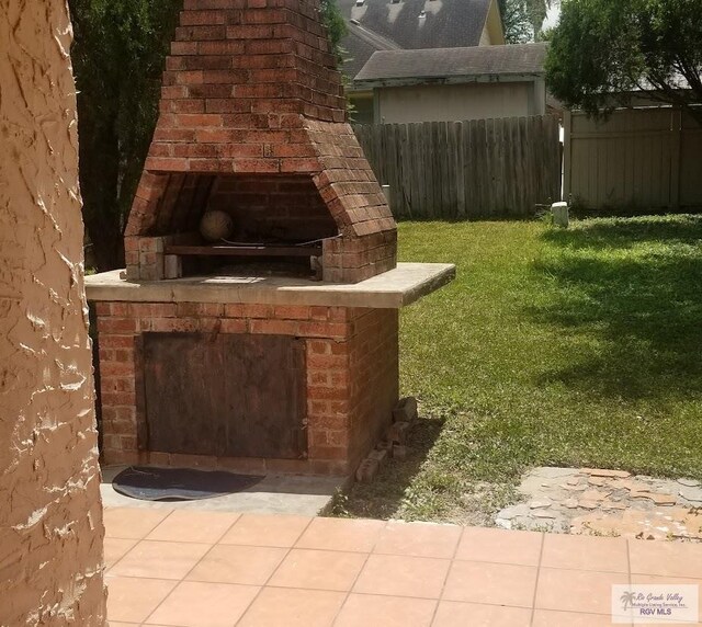 4853 Paseo Del Rey Dr, Brownsville, TX 78526 - view of yard with an outdoor brick fireplace
