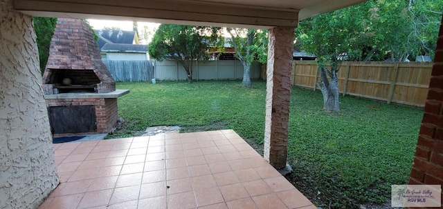 4853 Paseo Del Rey Dr, Brownsville, TX 78526 - fenced backyard with exterior fireplace and a patio area