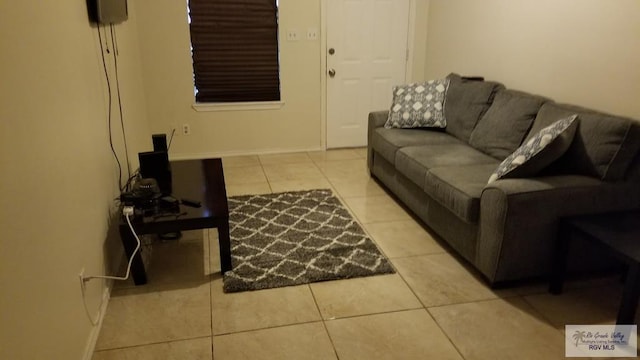 4853 Paseo Del Rey Dr, Brownsville, TX 78526 - living room featuring tile patterned floors and baseboards