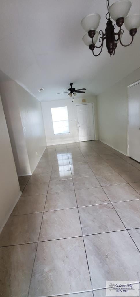 4853 Paseo Del Rey Dr, Brownsville, TX 78526 - spare room with light tile patterned floors, a chandelier, and ceiling fan