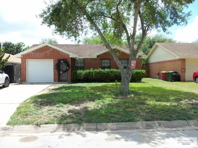 4853 Paseo Del Rey Dr, Brownsville, TX 78526 - ranch-style house with a garage, brick siding, driveway, and a front yard