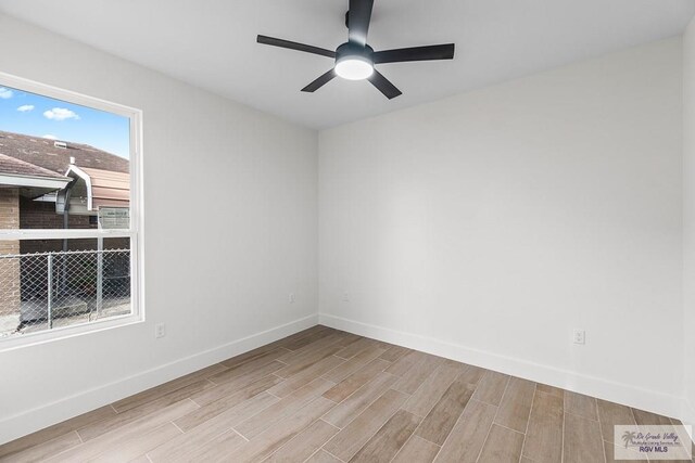1421 6th St, Harlingen, TX 78550 - spare room with wood finished floors, baseboards, and a ceiling fan