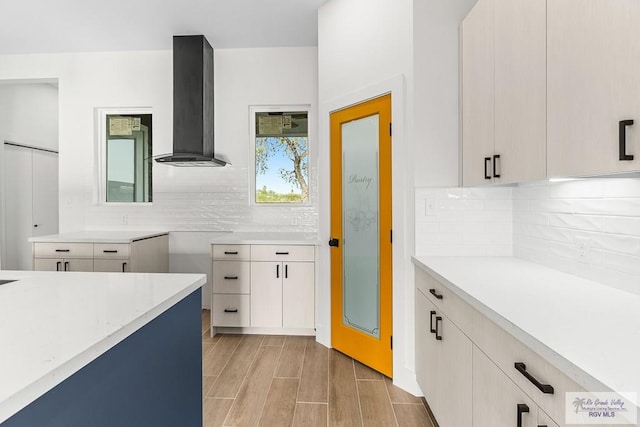 1421 6th St, Harlingen, TX 78550 - kitchen featuring wall chimney exhaust hood, light countertops, and backsplash