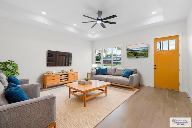 1421 6th St, Harlingen, TX 78550 - living room with recessed lighting, a tray ceiling, a ceiling fan, light wood-type flooring, and baseboards