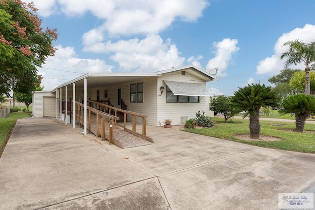 view of front of home with a front lawn and a carport