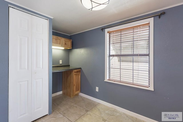 kitchen with built in desk and ornamental molding