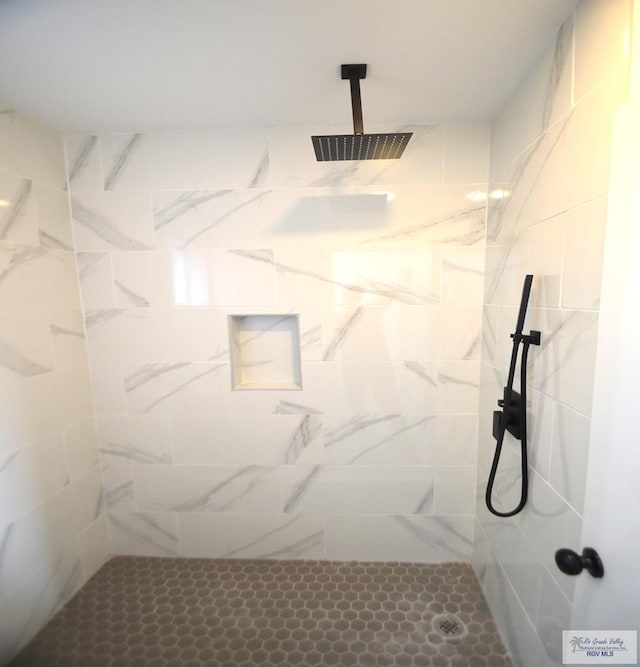 bathroom with a tile shower