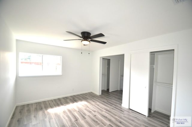 unfurnished bedroom with ceiling fan and light wood-type flooring