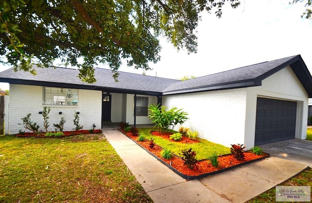 ranch-style home featuring a garage and a front lawn