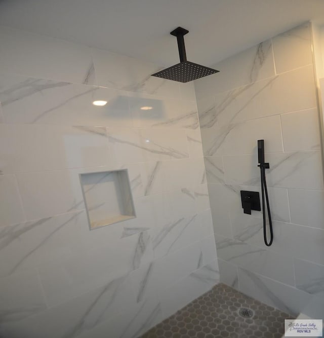 bathroom with a tile shower