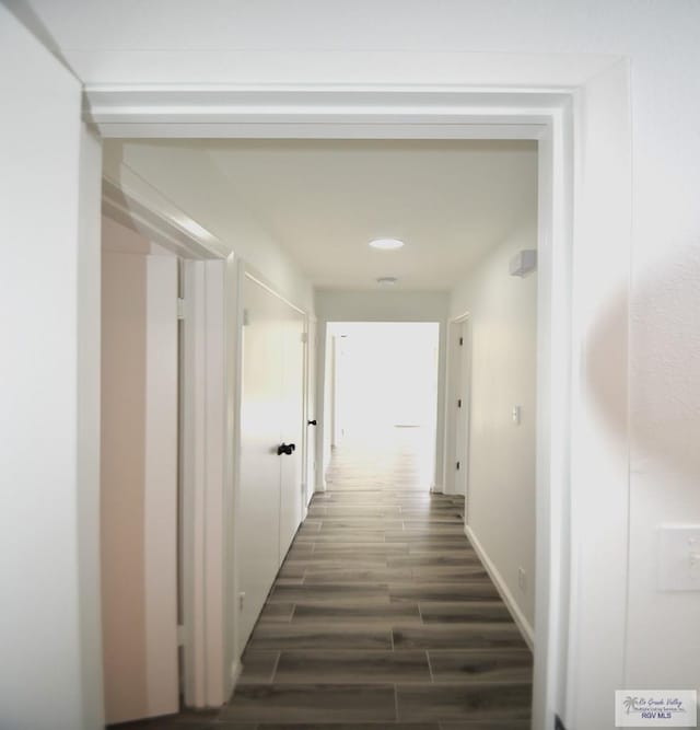 hallway with dark wood-type flooring