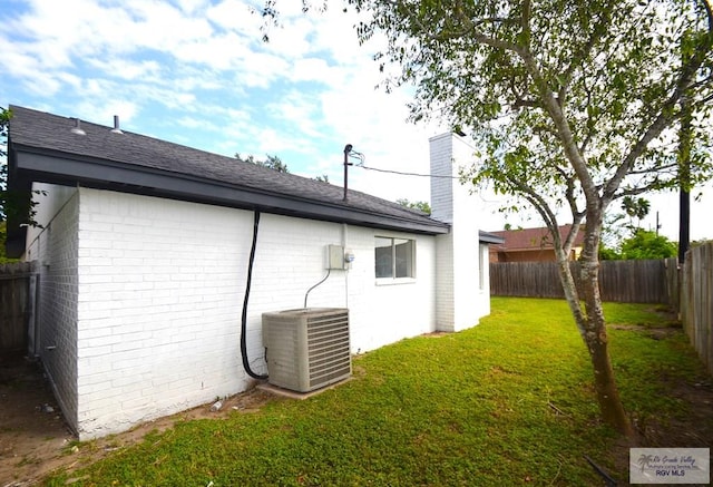 view of home's exterior featuring central AC unit and a lawn