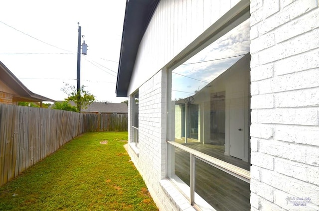 view of side of home featuring a lawn