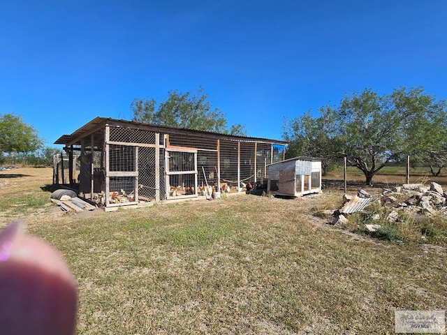 rear view of property with an outbuilding