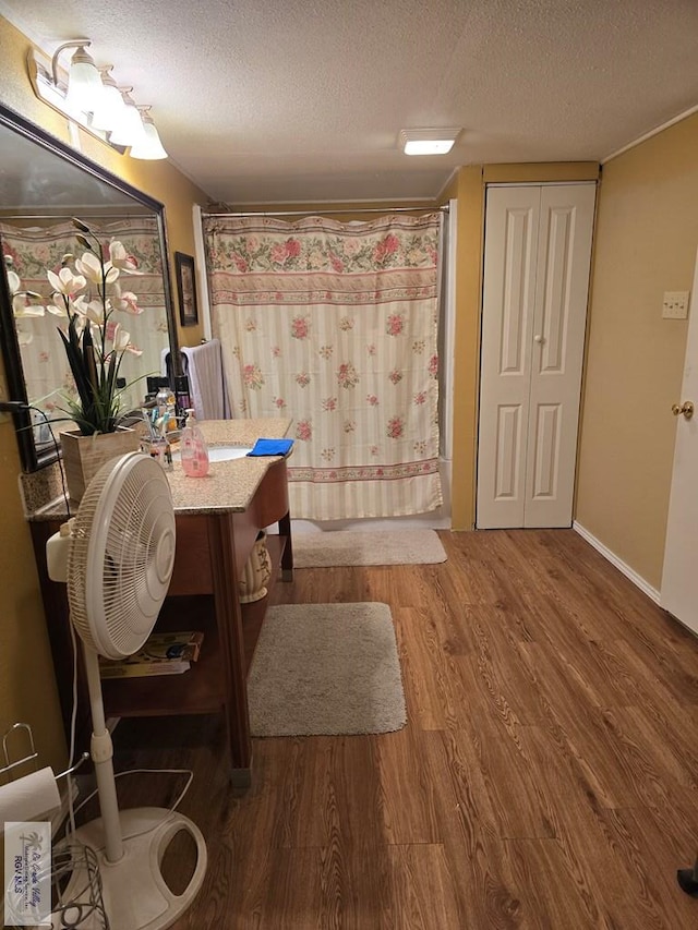 bathroom with a shower with curtain, vanity, a textured ceiling, and hardwood / wood-style flooring