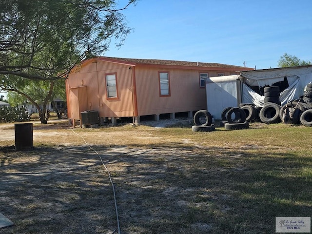 view of side of property with cooling unit