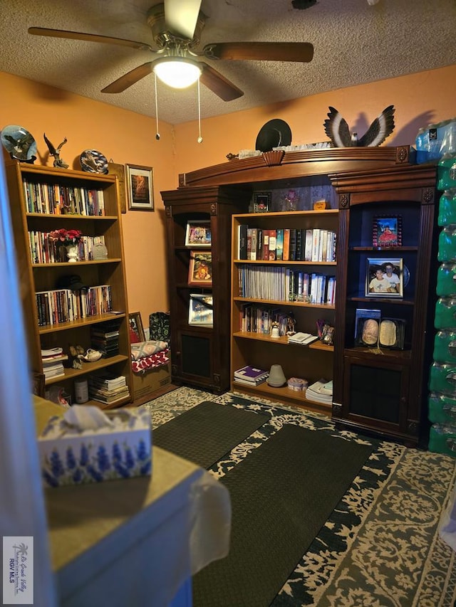 living area featuring a textured ceiling