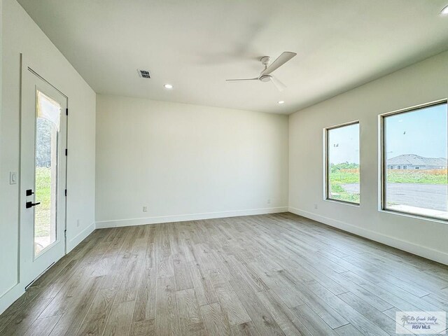 spare room featuring light hardwood / wood-style floors and ceiling fan