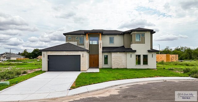 view of front of house with a garage and a front lawn