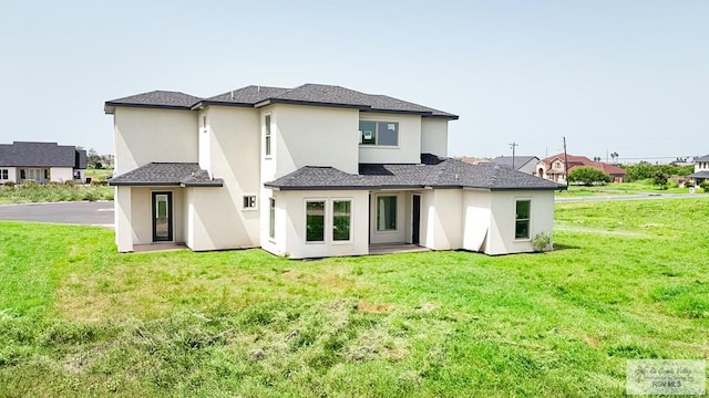 back of house featuring a lawn