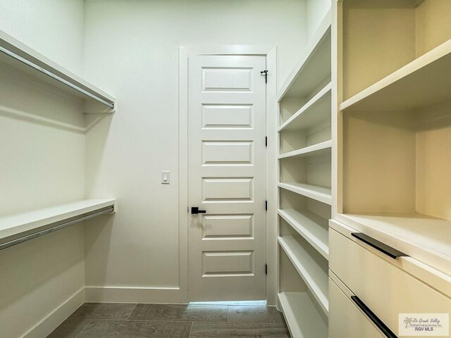 walk in closet featuring dark hardwood / wood-style floors