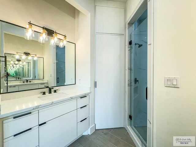 bathroom with vanity and a shower with shower door