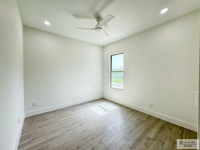 spare room with ceiling fan and light hardwood / wood-style floors