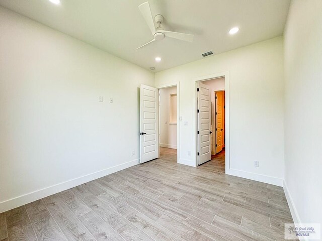 unfurnished bedroom with ceiling fan and light wood-type flooring