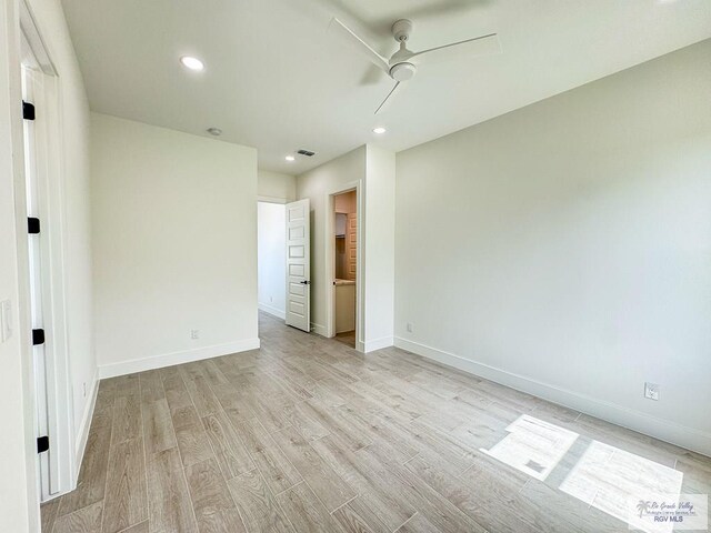 unfurnished room featuring ceiling fan and light wood-type flooring