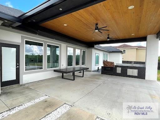 view of patio featuring ceiling fan