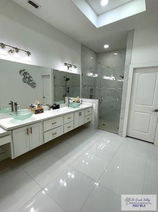 bathroom with vanity, tile patterned floors, and an enclosed shower