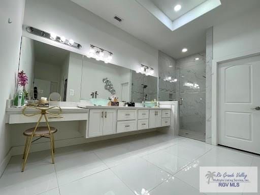 bathroom featuring vanity, tile patterned floors, and a shower with door