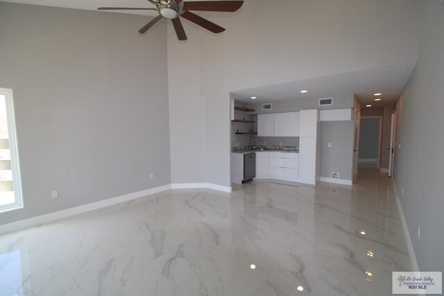 200 Padre Blvd Unit 2307, South Padre Island, TX 78597 - unfurnished living room featuring ceiling fan, sink, and a high ceiling