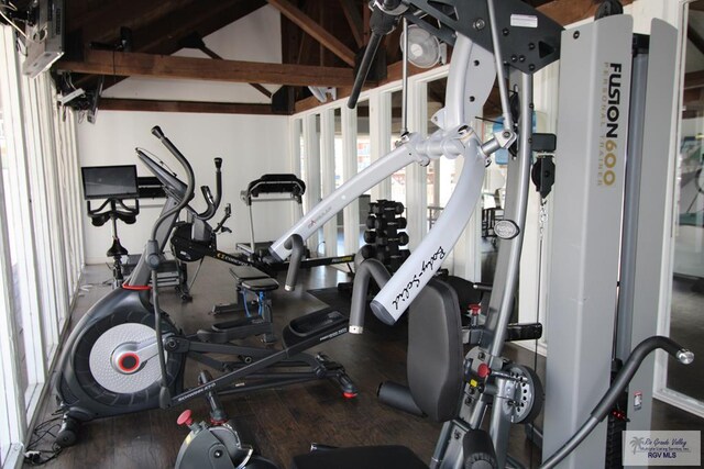 200 Padre Blvd Unit 2307, South Padre Island, TX 78597 - exercise room featuring vaulted ceiling and hardwood / wood-style flooring