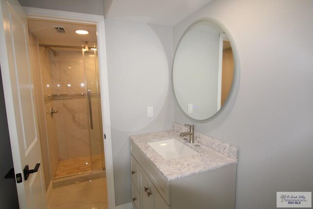 200 Padre Blvd Unit 2307, South Padre Island, TX 78597 - bathroom featuring tile patterned floors, vanity, and a shower with shower door
