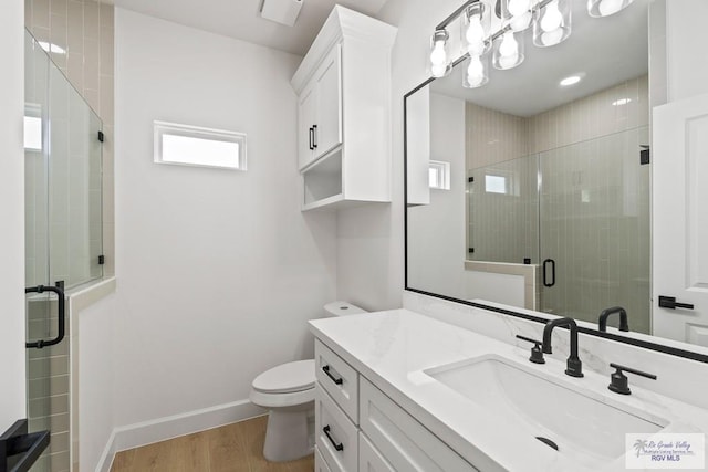 29002 Reynolds Dr # 18, La Feria, TX 78559 - bathroom with vanity, a shower stall, and wood finished floors