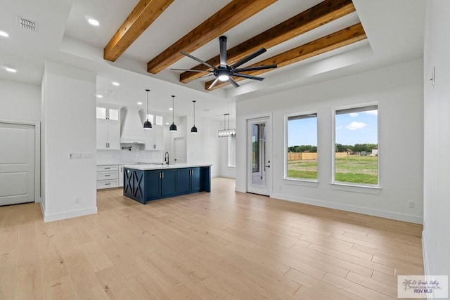 29002 Reynolds Dr # 18, La Feria, TX 78559 - unfurnished living room with beamed ceiling, ceiling fan, light wood-style floors, and recessed lighting