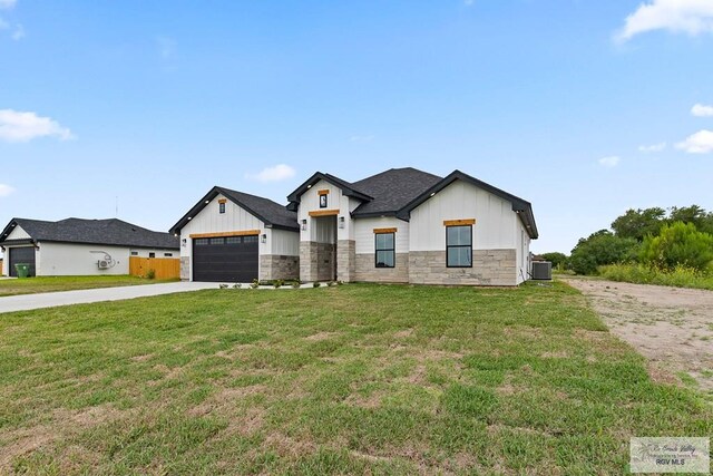 29002 Reynolds Dr # 18, La Feria, TX 78559 - modern farmhouse with board and batten siding, concrete driveway, stone siding, and a front lawn