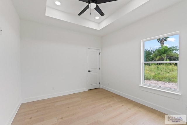 29002 Reynolds Dr # 18, La Feria, TX 78559 - empty room with light wood-style floors, ceiling fan, recessed lighting, and a raised ceiling
