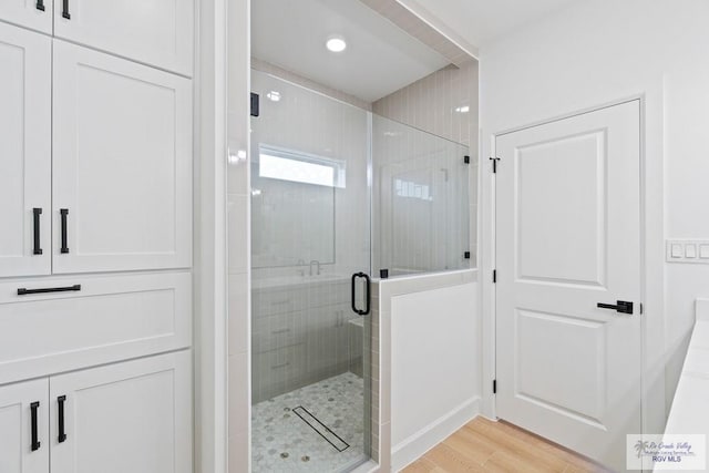 29002 Reynolds Dr # 18, La Feria, TX 78559 - bathroom featuring a shower stall and wood finished floors